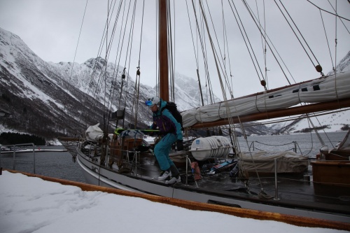 Stepping off the boat with my skis