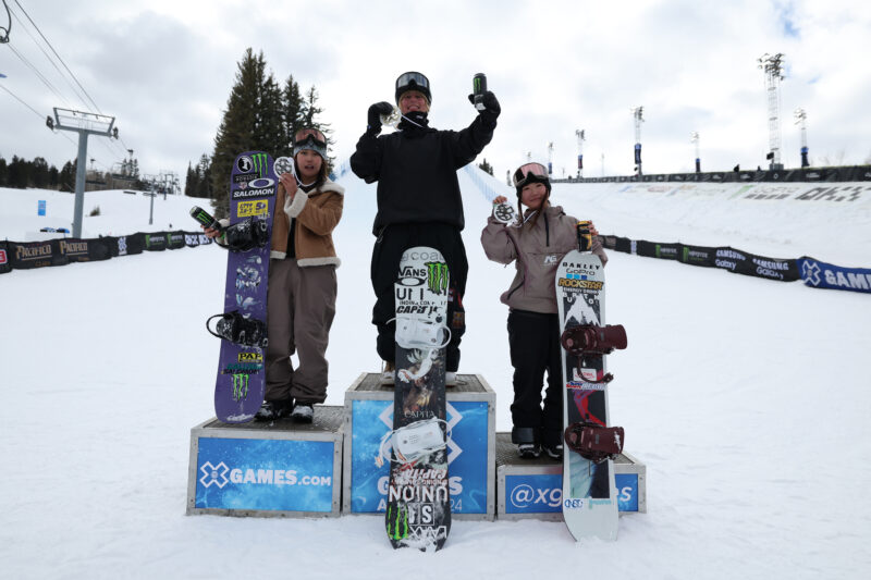 Kokomo Murase, Mia Brookes, and Reira Iwabuchi at the podium during Women's Snowboard Slopestyle at 2024 X Games Aspen at Buttermilk in Aspen, CO. ©Mpu Dinani/X Games